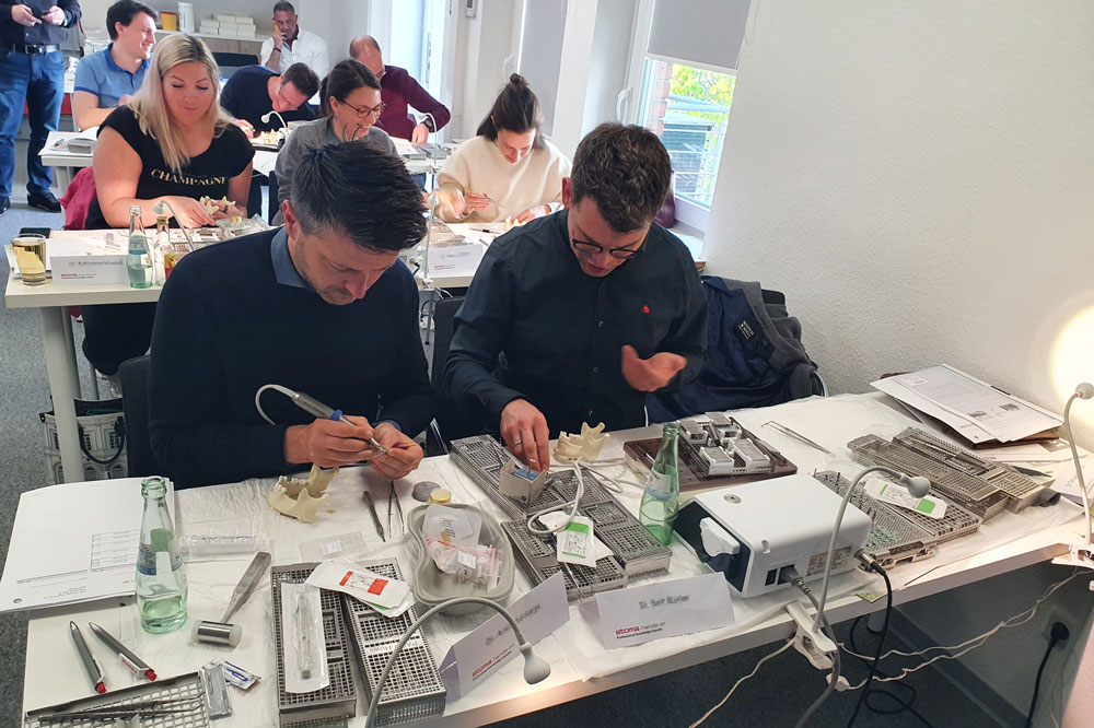 Participants working with instruments on jaw models